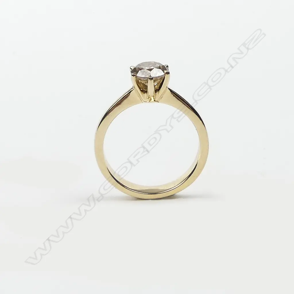 A 14ct yellow gold and diamond solitaire ring Image 1++