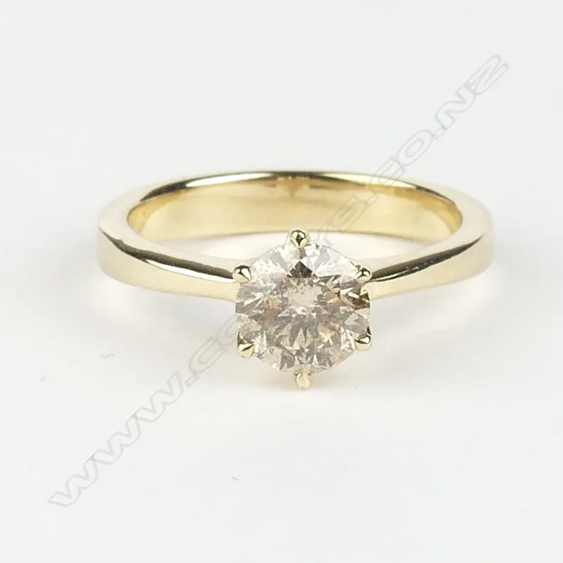 A 14ct yellow gold and diamond solitaire ring Image 1++