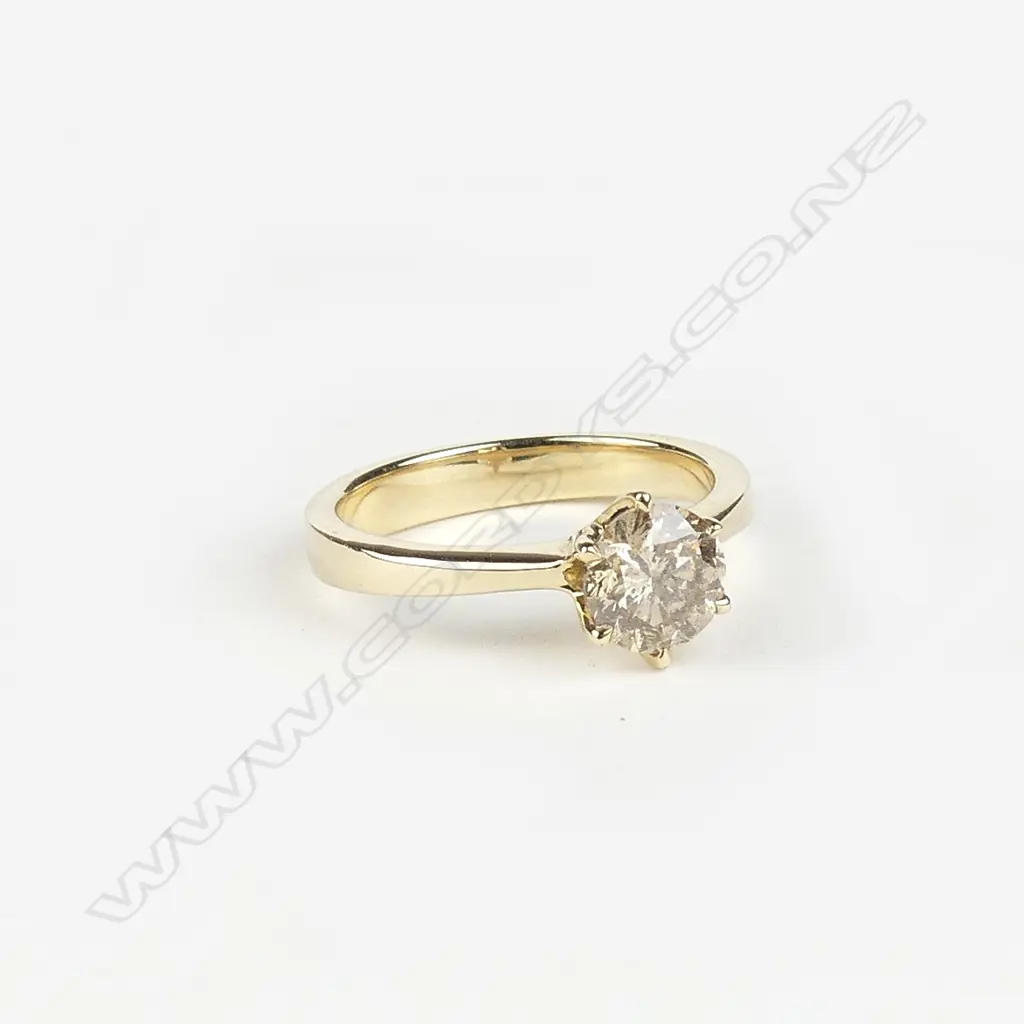 A 14ct yellow gold and diamond solitaire ring Image 1++