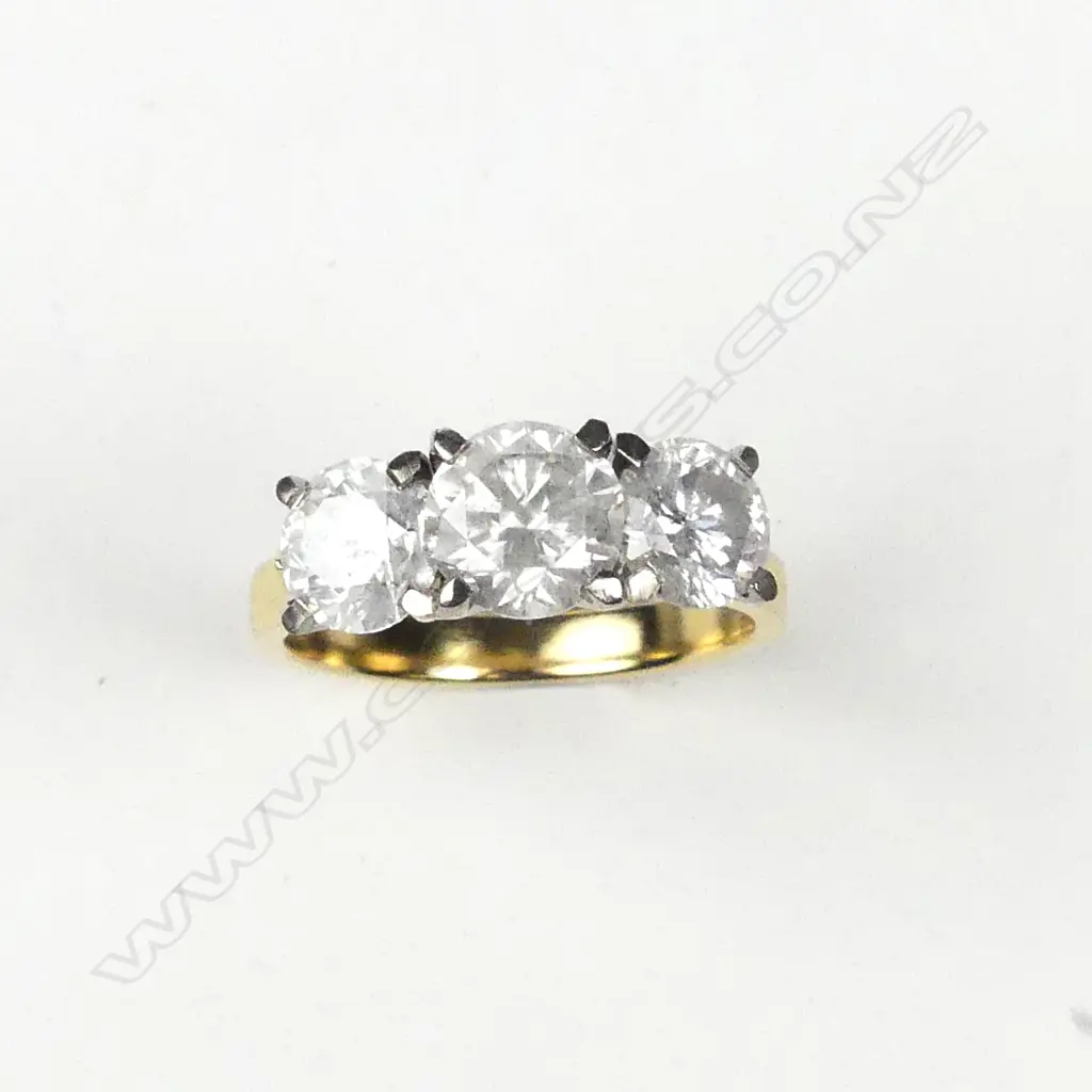 An 18ct yellow and white gold diamond trilogy ring Image 1++