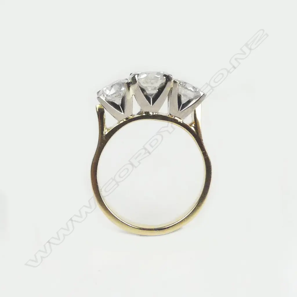 An 18ct yellow and white gold diamond trilogy ring Image 1++