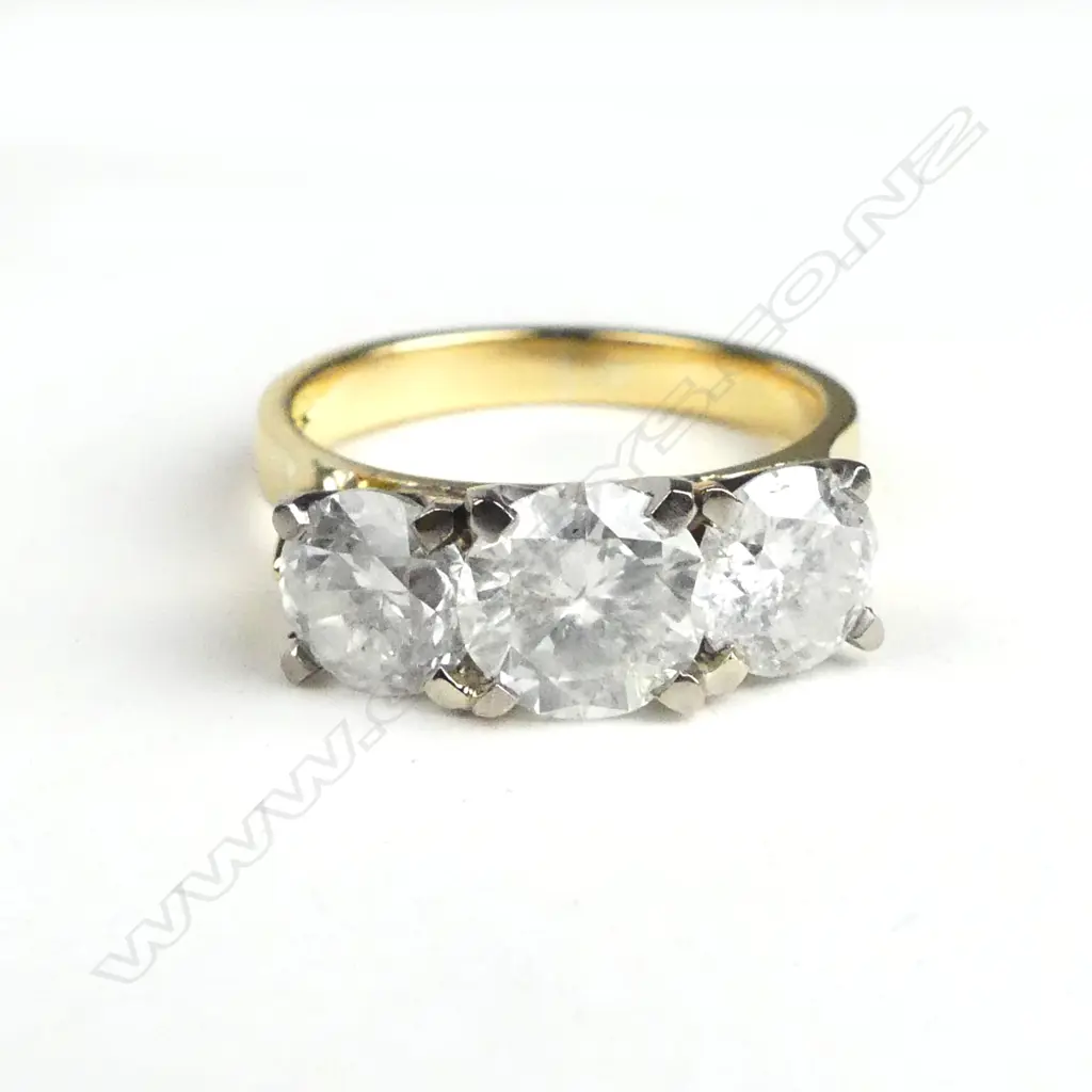 An 18ct yellow and white gold diamond trilogy ring Image 1++