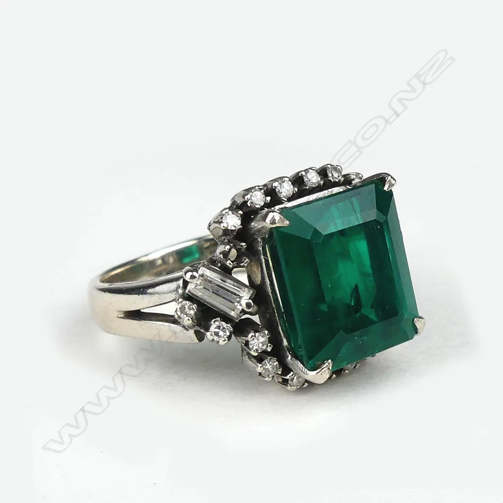A diamond and faux emerald ring Image 1++