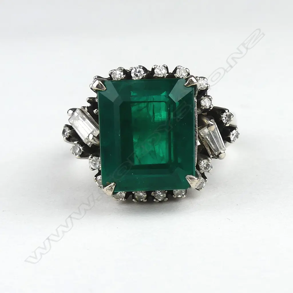 A diamond and faux emerald ring Image 1++