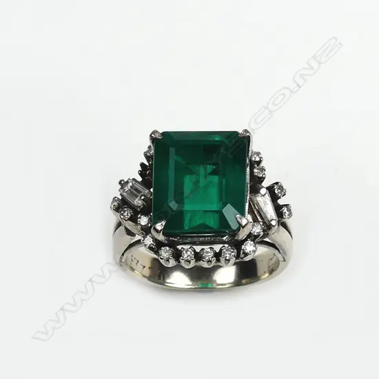 A diamond and faux emerald ring