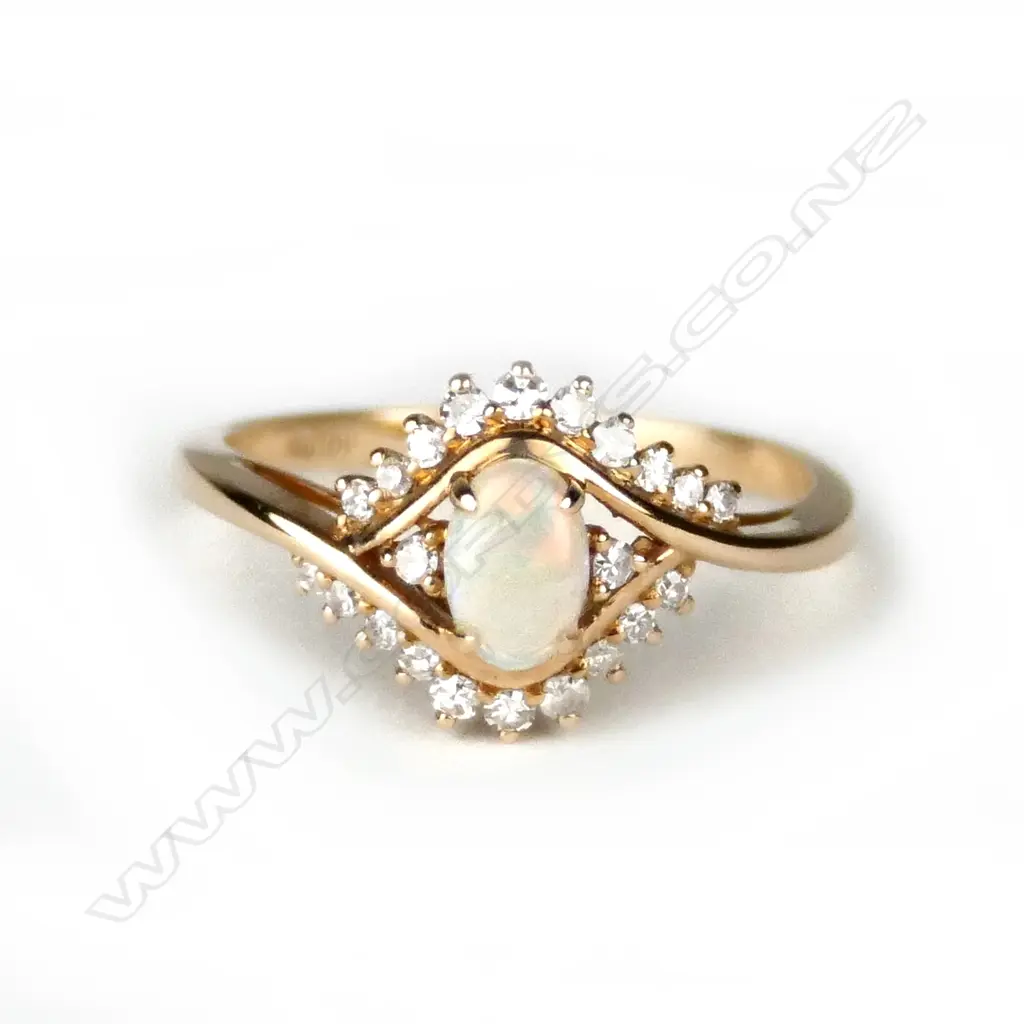A modern 18ct. yellow gold opal and diamond dress ring Image 1++