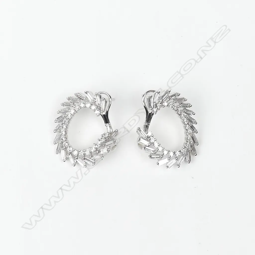 A pair of 18ct. white gold and multi-diamond C-scroll form earrings Image 1++