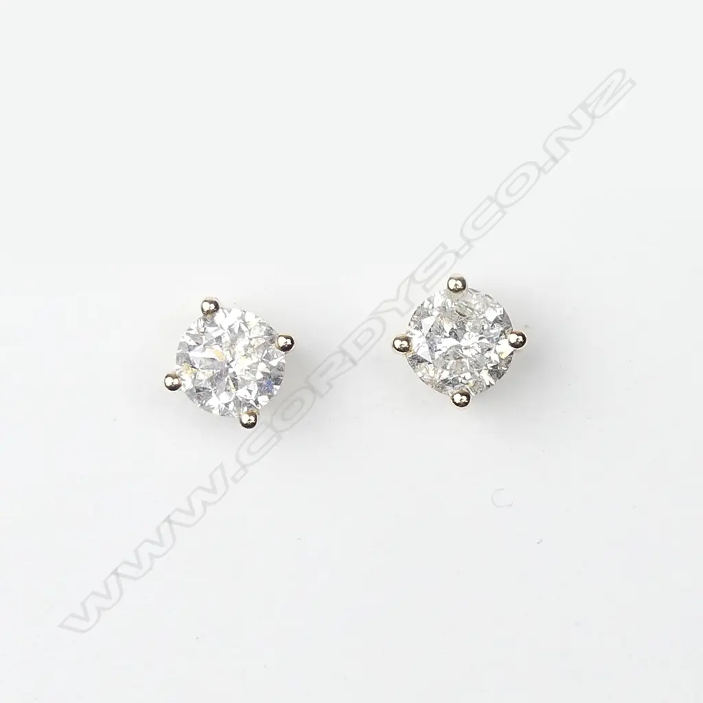 A pair of 14ct gold and diamond stud earrings Image 1++