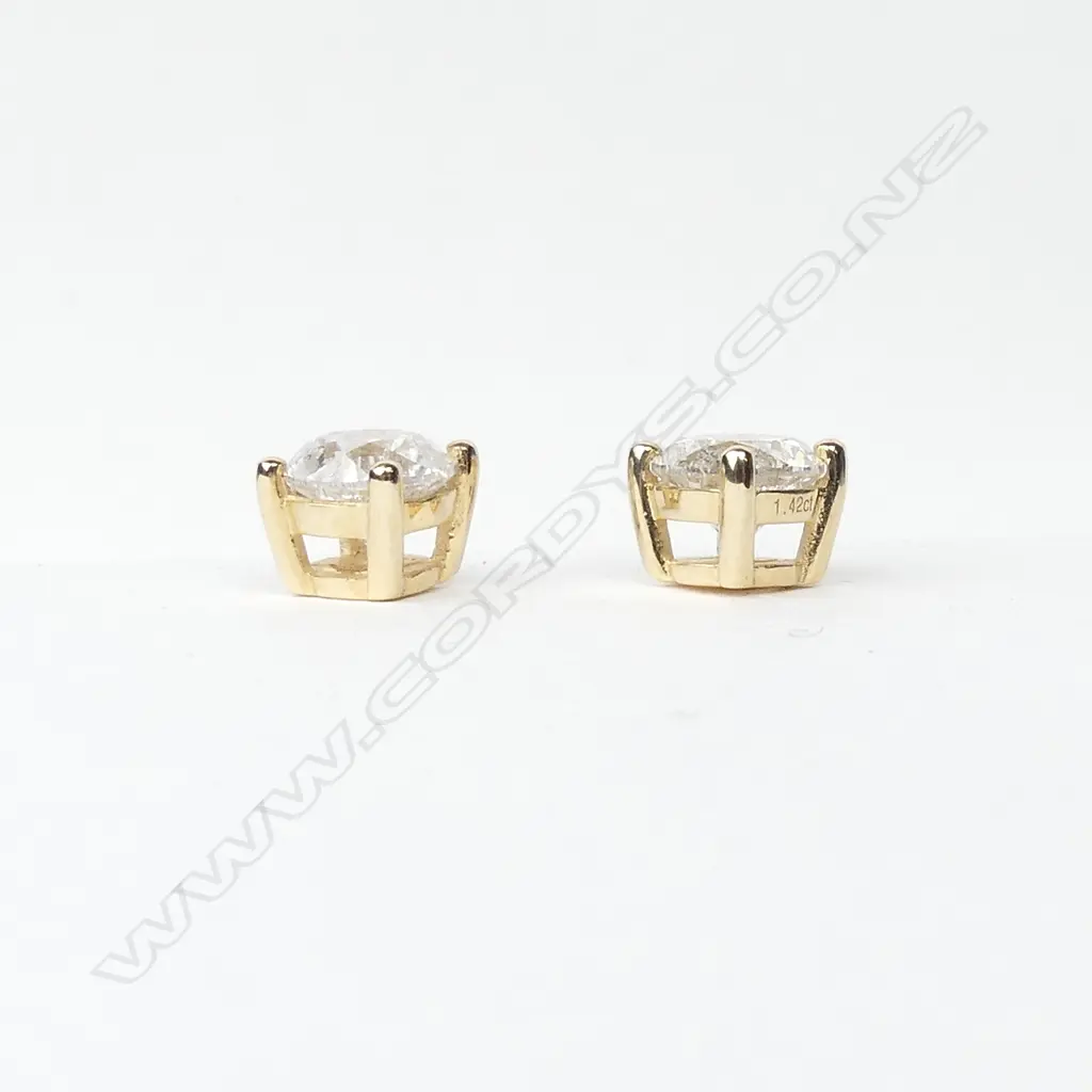 A pair of 14ct gold and diamond stud earrings Image 1++