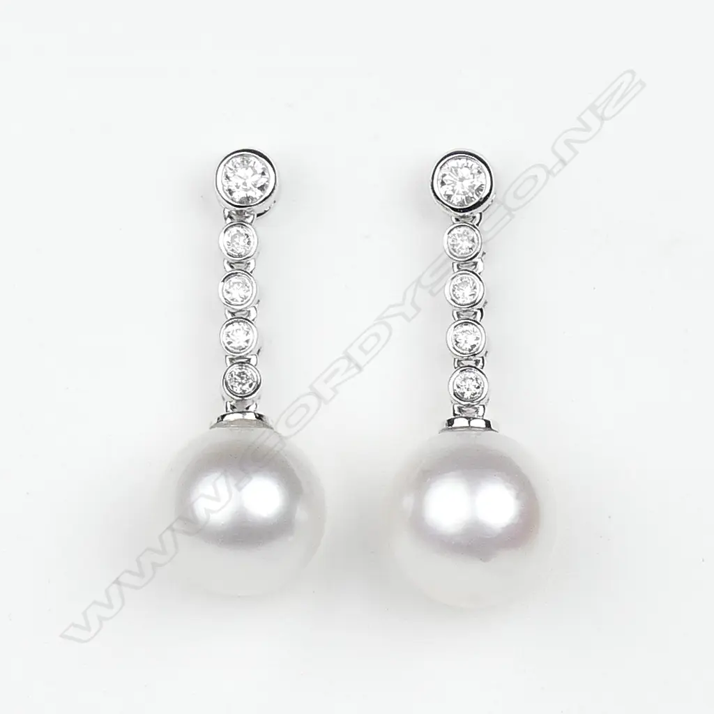 A pair of 14ct white gold diamond and pearl drop earrings Image 1++