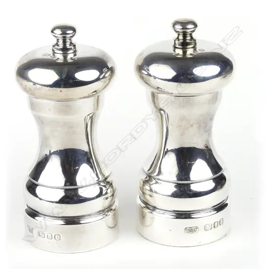 A pair of modern silver capstan pepper mills