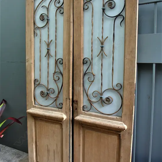 A pair of 19thC French decorative glazed and wrought iron work doors