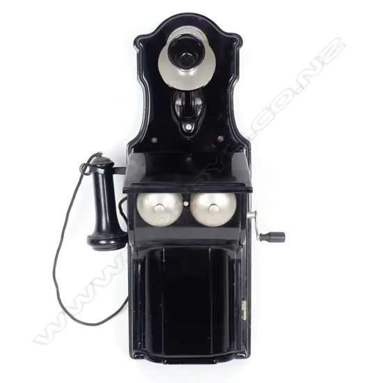 A vintage Stromburg-Carlson enamel wall phone