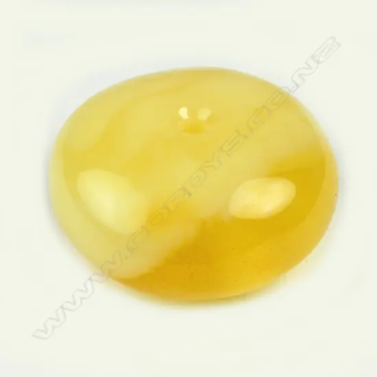 A large egg yolk amber bead of rounded flattened form