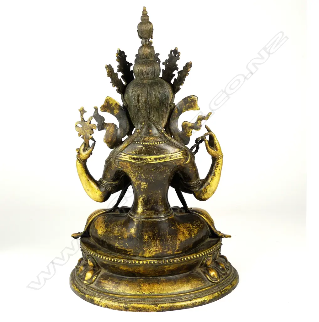 An old Chinese seated bronze of the Tibetan bodhisattva Tārā modelled with four arms Image 1++