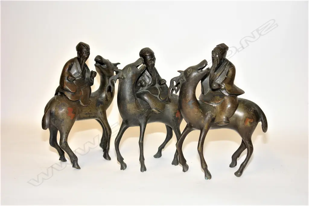 A set of three old Chinese bronze immortal figures on deer Image 1++