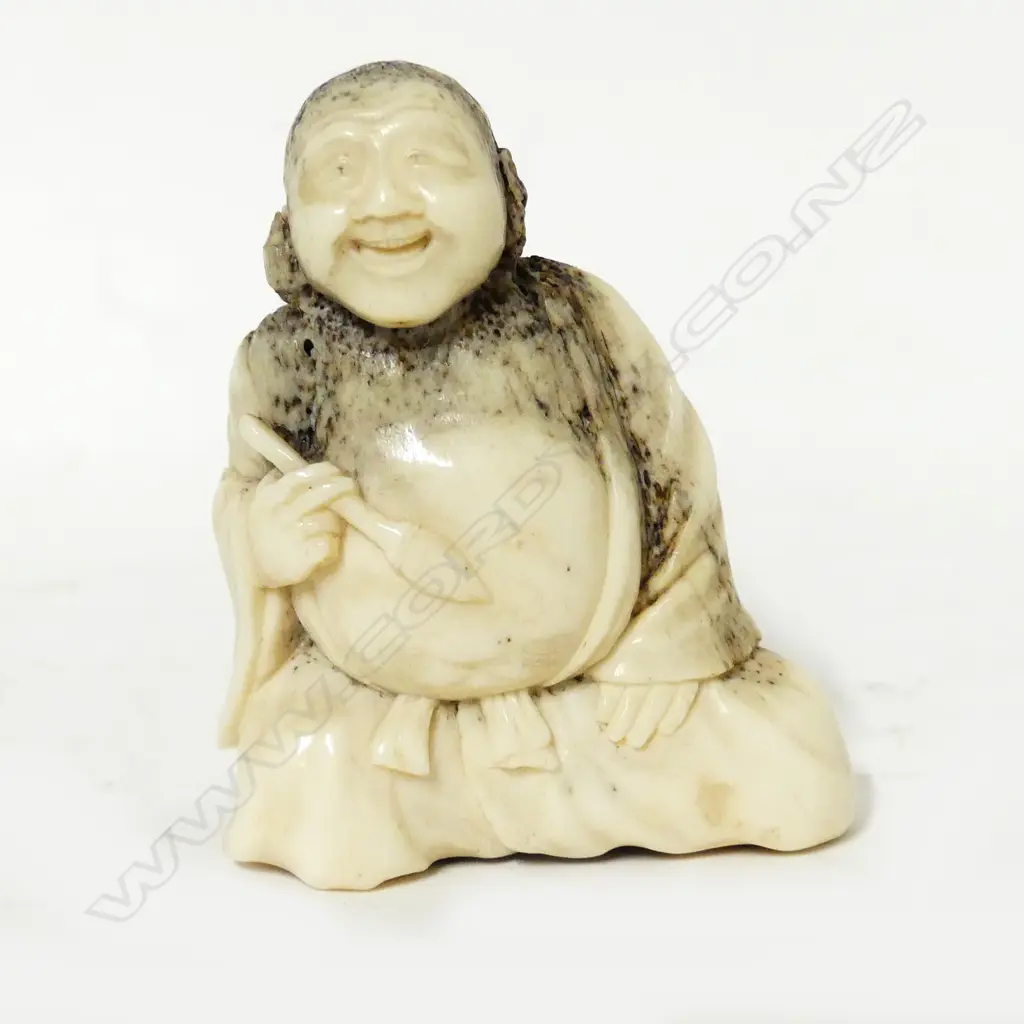 An old deer antler carving of a man Image 1++