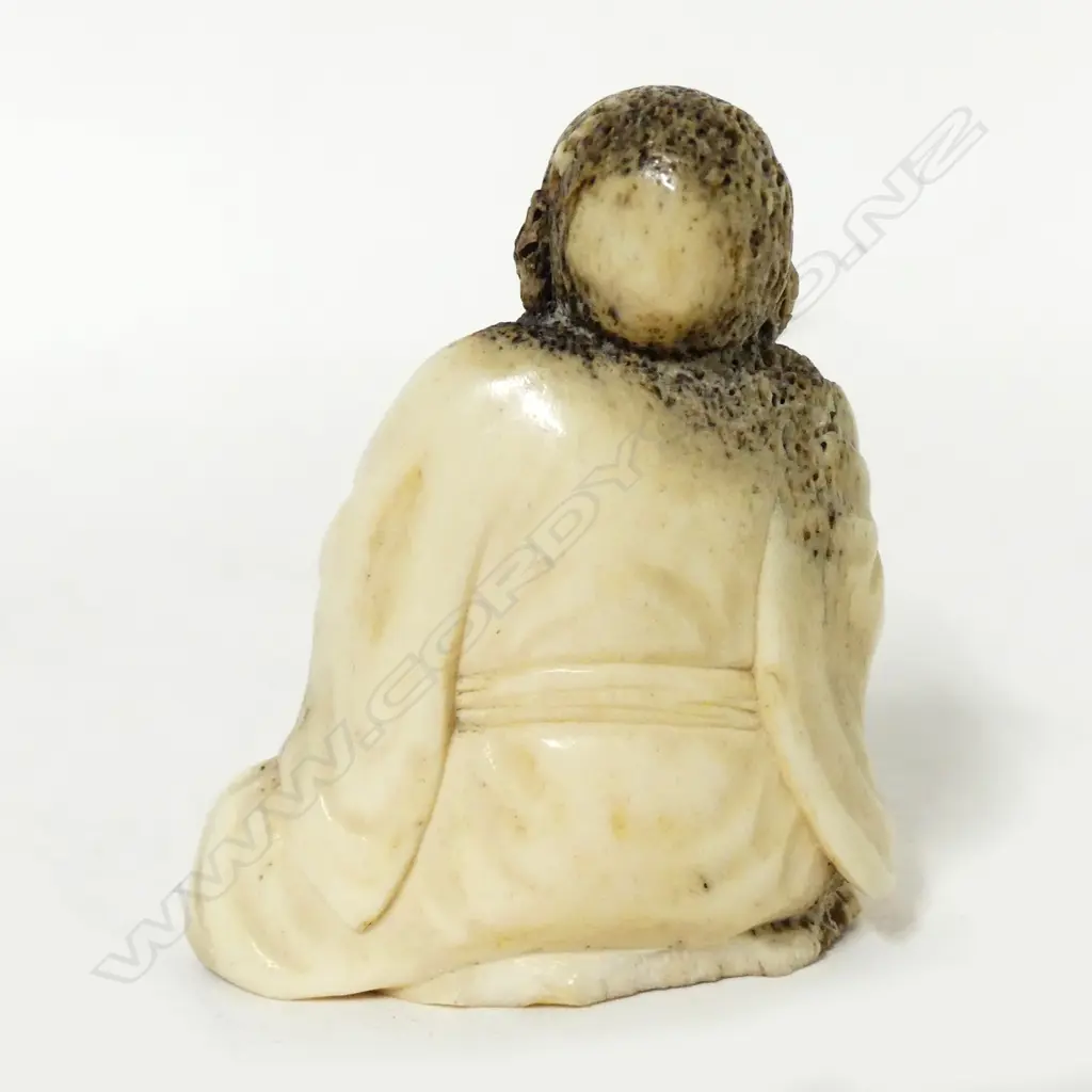 An old deer antler carving of a man Image 1++