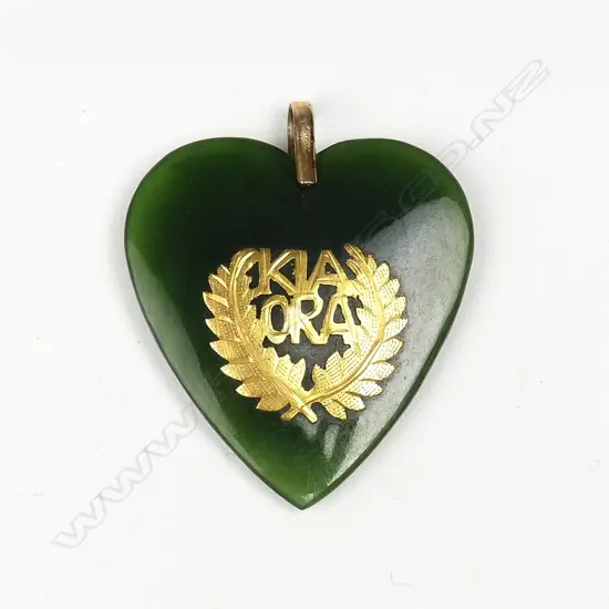 An early 20thC N.Z. colonial greenstone and gilded 9ct. gold 'Kia Ora' heart pendant