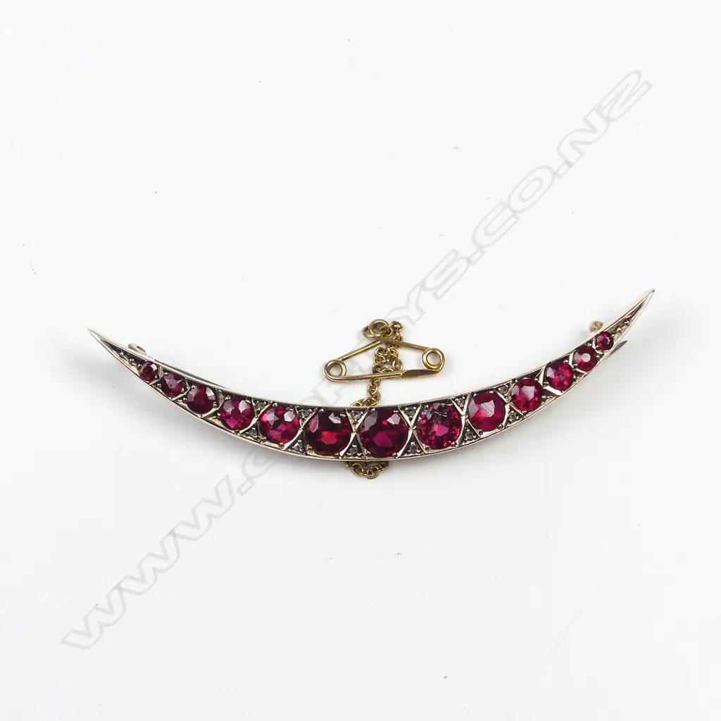 An early 20thC 9ct. rose gold faux ruby crescent brooch Image 1++