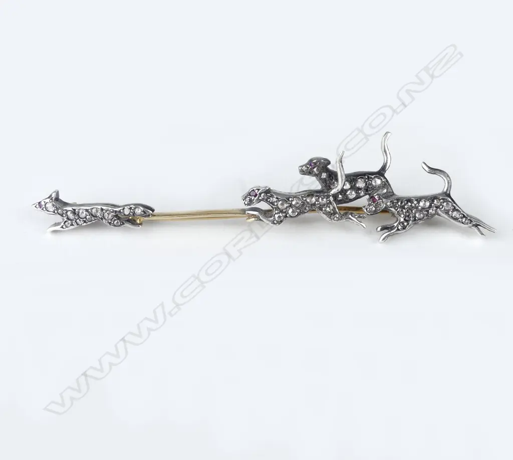 A decorative gold silver and diamond set fox hunting brooch Image 1++