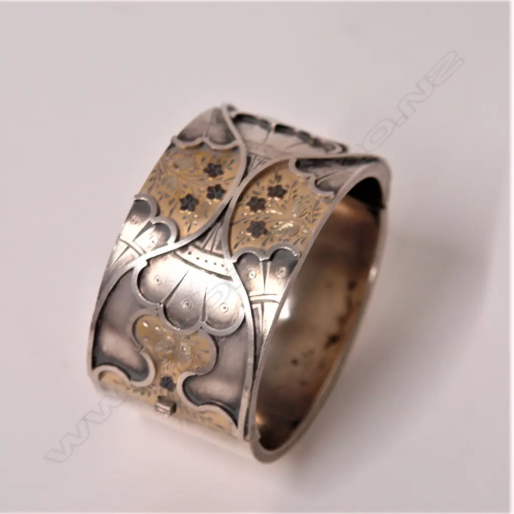 A late Victorian Arts and Craft wide silver hinged bangle Image 1++