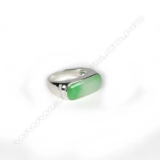 A modern 18ct. white gold jadeite and diamond dress ring