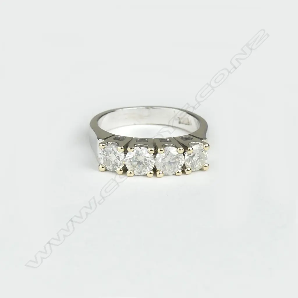 An 18ct white and yellow gold four stone diamond ring Image 1++