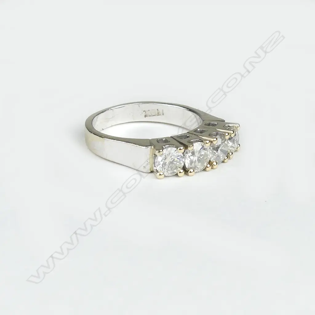 An 18ct white and yellow gold four stone diamond ring Image 1++
