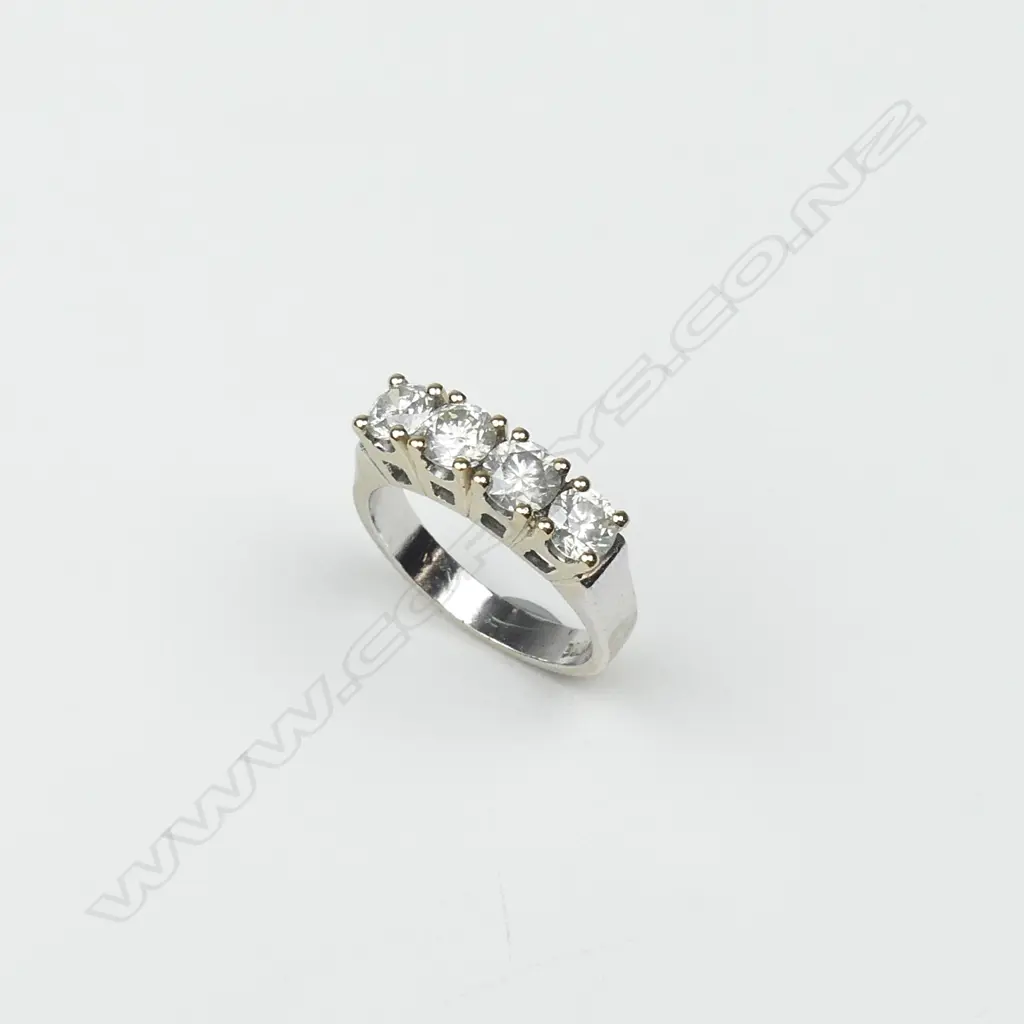 An 18ct white and yellow gold four stone diamond ring Image 1++
