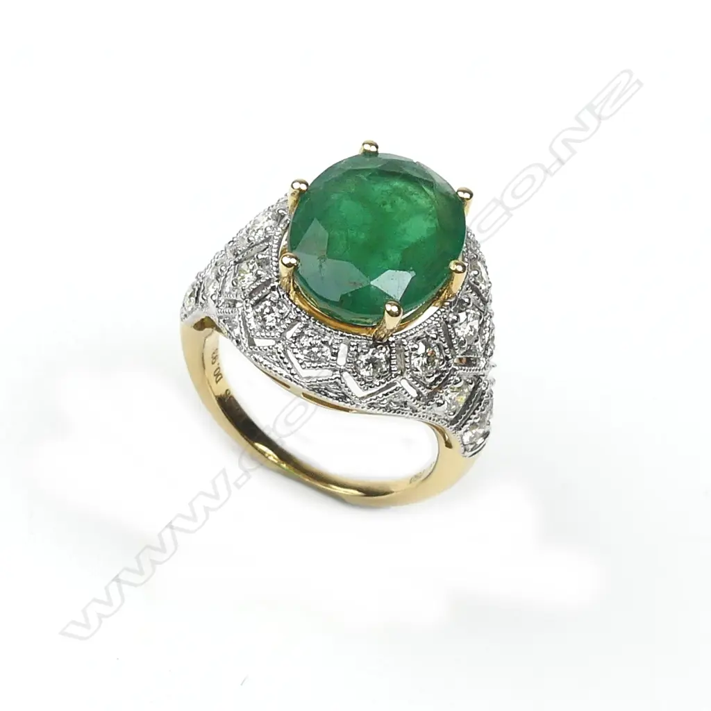 An 18ct yellow and white gold emerald and diamond ring Image 1++
