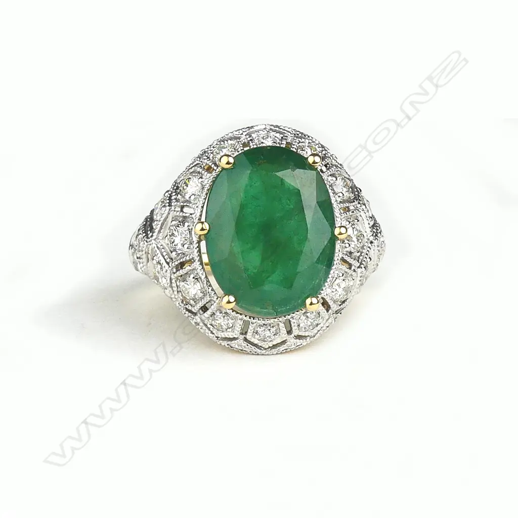 An 18ct yellow and white gold emerald and diamond ring Image 1++