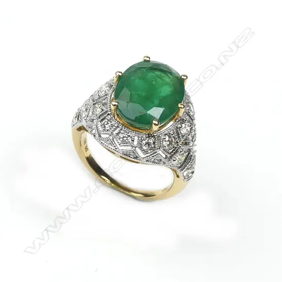 An 18ct yellow and white gold emerald and diamond ring