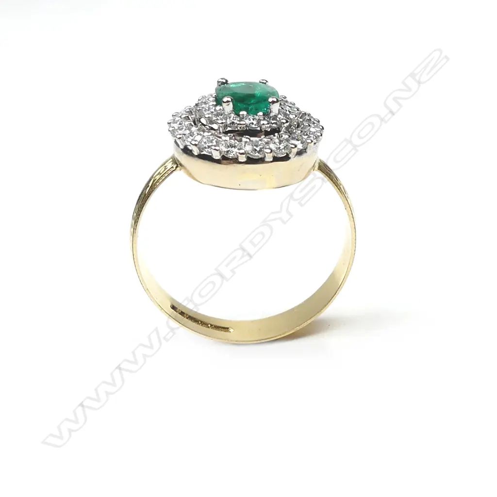 An 18ct yellow and white gold emerald and diamond ring Image 1++
