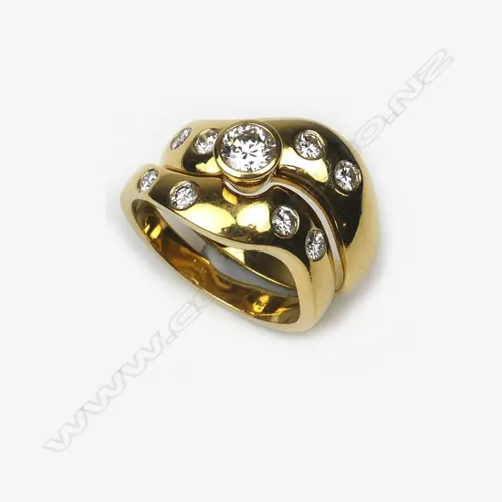 An 18ct. yellow gold and diamond solitaire and wedding ring set