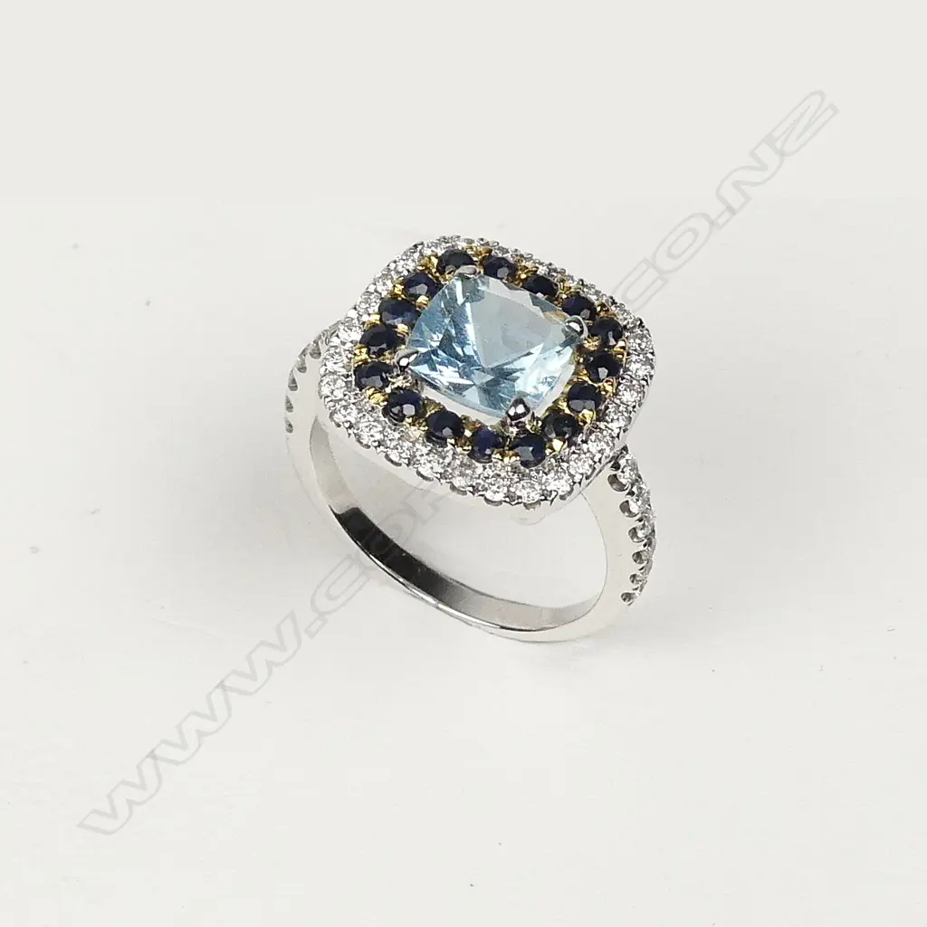 An 18ct white gold aquamarine diamond and sapphire ring Image 1++