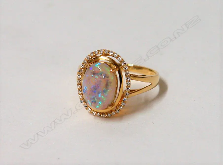 A modern 18ct. yellow gold opal and diamond ring Image 1++