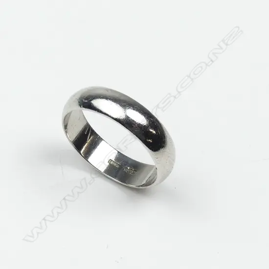 A modern platinum half-hoop band ring
