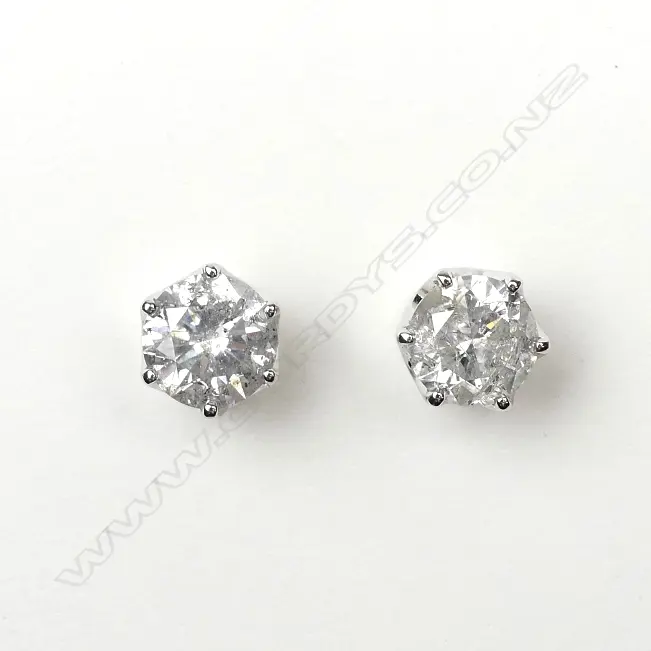A pair of 14ct white gold and diamond stud earrings Image 1++