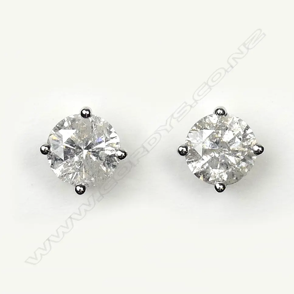 A pair of 14ct white gold and diamond stud earrings Image 1++