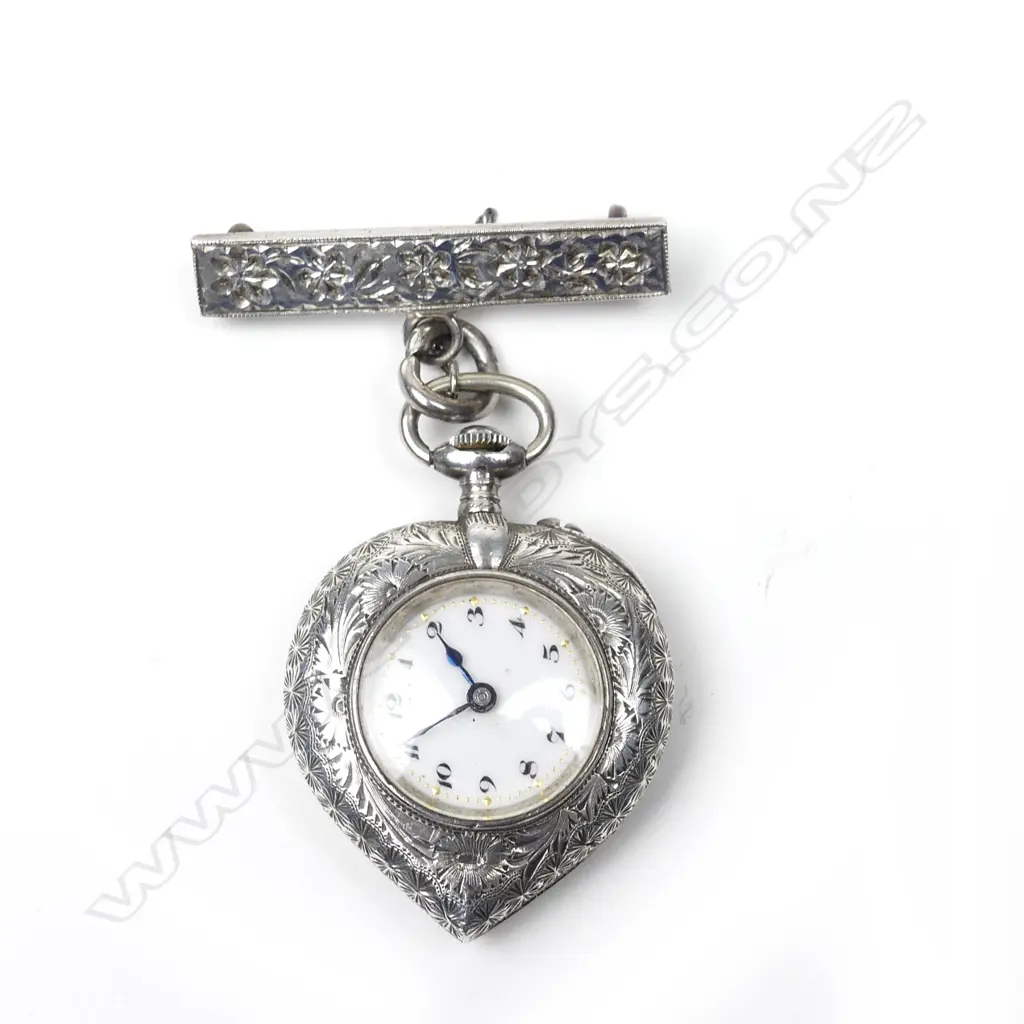 A lady's silver heart shaped pocket watch Image 1++
