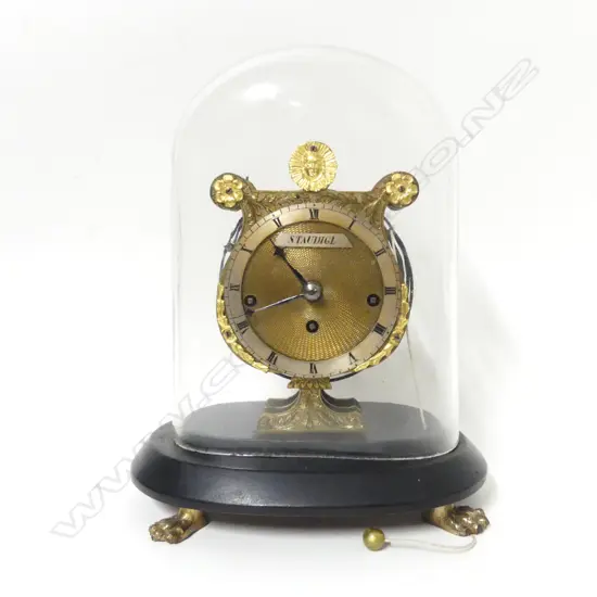 A small lyre shaped boudoir clock