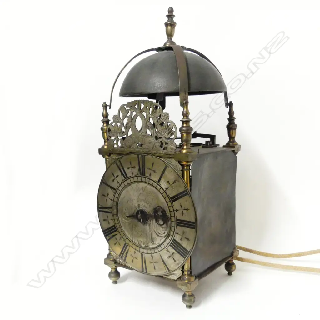 An early 18thC brass lantern clock by Robert Coster of Newbury with bell over dolphin fret and four urn finials Image 1++