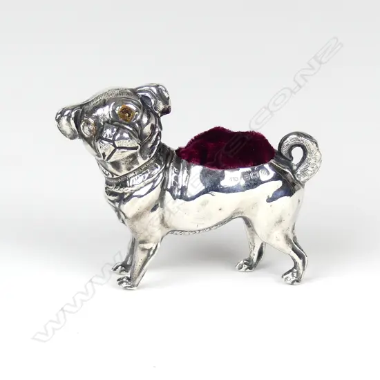 A rare early 20thC novelty dog silver pin cushion