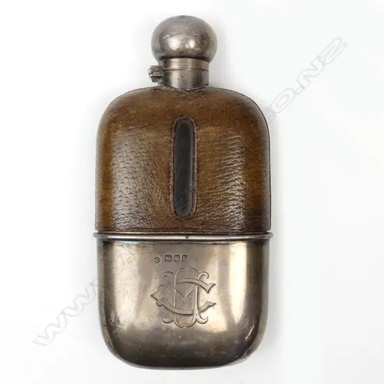 An Edwardian silver glass and leather gentleman's hip flask