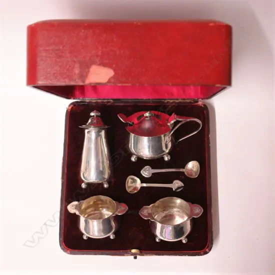 A good Art Nouveau silver four piece condiment set plus spoons