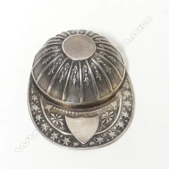 A silver jockey's cap caddy spoon