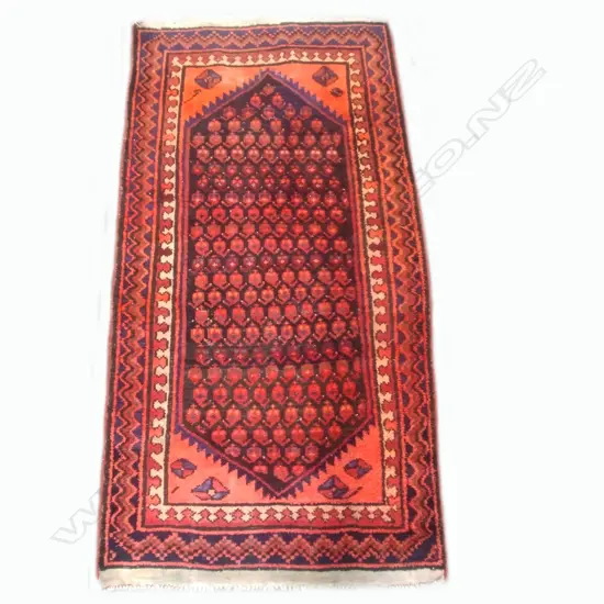 An antique hand knotted Ferdos rug