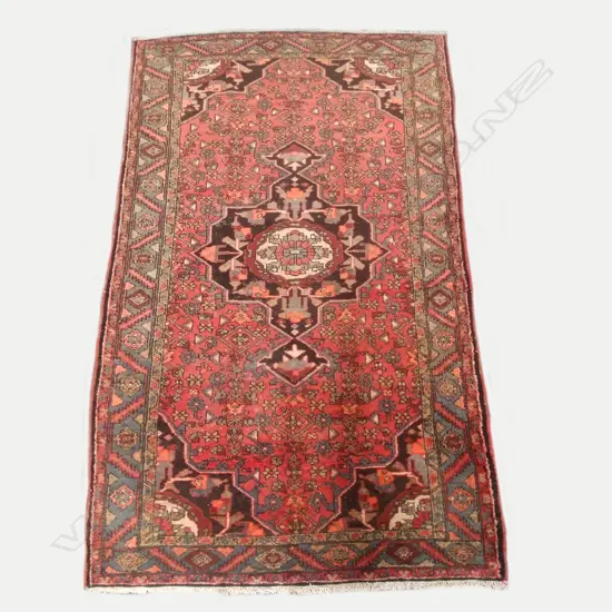 An antique hand knotted Hamadan rug