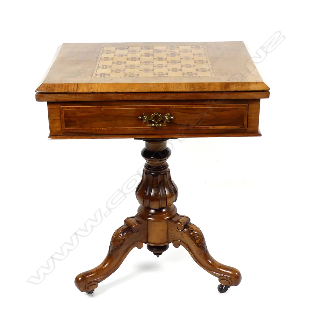 A Victorian walnut games table Image 1++